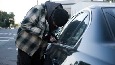 Car thief stealing a car